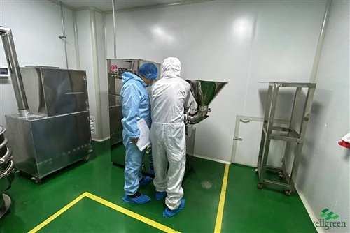 info-500-1 Feed-grade additive production area with operators in protective clothing and stainless steel equipment