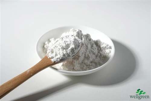 White crystalline powder sample with a scoop in a white dish