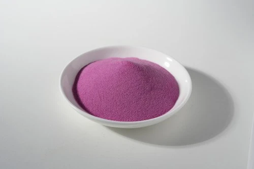 Milled deep-pink botanical powder presented in a white dish