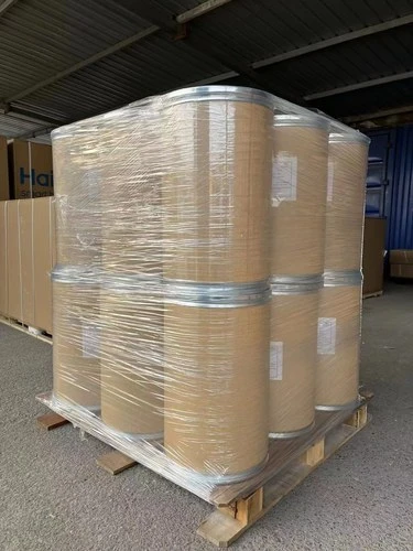 Pallets of lined fibre drums of bulk powder staged in a warehouse