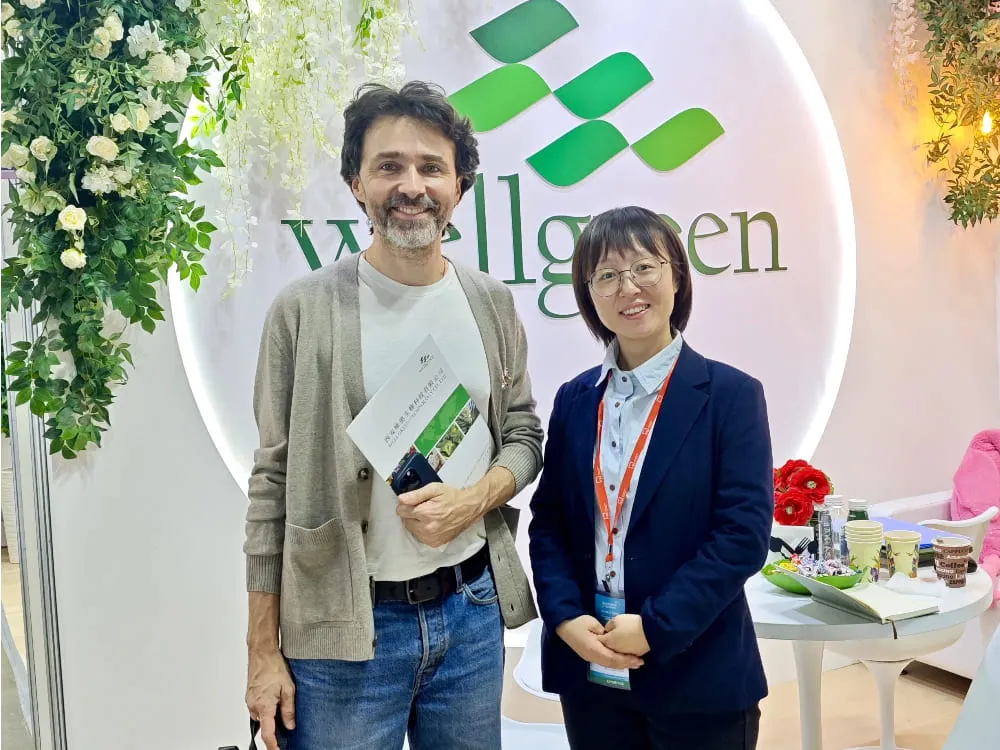A Wellgreen team member actively discusses ingredient specifications and applications with a group of international attendees at the booth. A Wellgreen team member actively discusses ingredient specifications and applications with a group of international attendees at the booth.